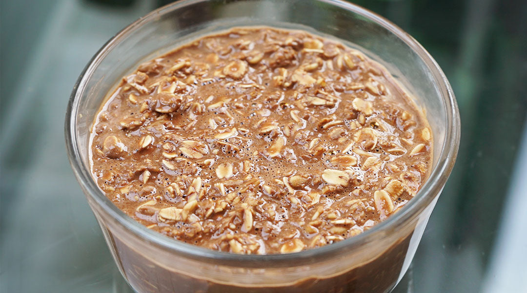 A glass cup filled with chocolate oatmeal