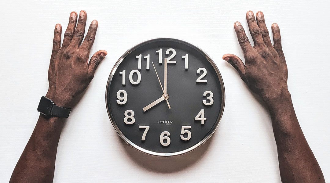 hands on either side of a clock